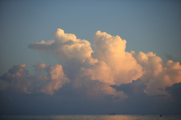 Beautiful clouds over ocean sunset water surface with reflections