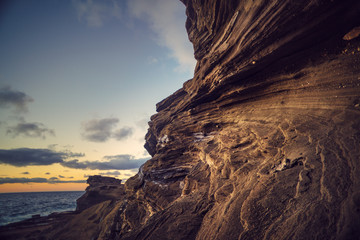 Rocky coastline with sunrise sky background