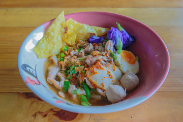Noodle sukhothai with spicy soup in vintage bowl.