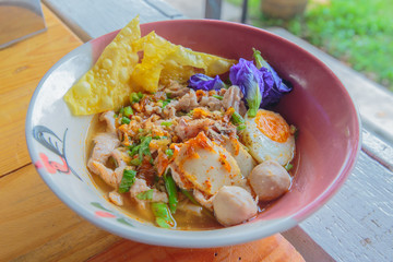 Noodle sukhothai with spicy soup in vintage bowl.