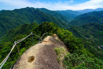 Dangerous hiking trail along a narrow and rocky mountain ridge at Wu Liao Jian in Taiwan - 149938076