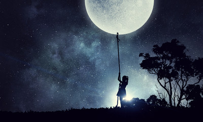 Kid girl catching moon