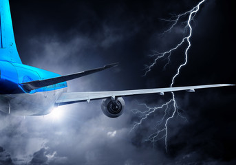 Airplane flying in stormy sky . Mixed media