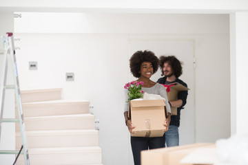 multiethnic couple moving into a new home