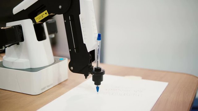 NOVEMBER 5, 2016 RUSSIA, MOSCOW Robotics Expo.Close-up of robot calligraphy with beautiful handwriting. 4K