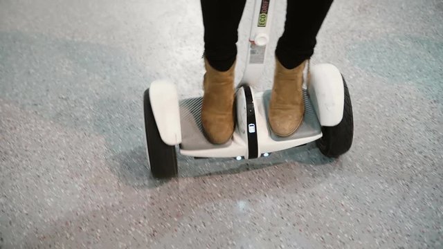 NOVEMBER 5, 2016 RUSSIA, MOSCOW Robotics Expo.Close-up of woman s feet on Segway. Scooter goes in the circle. 4K