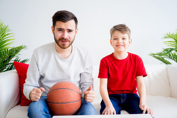 Father and son watching basketball