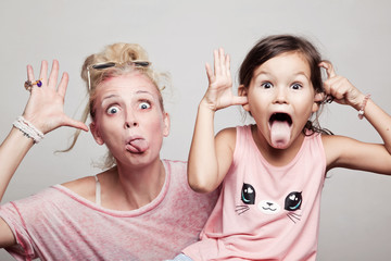 Little daughter with mum making faces