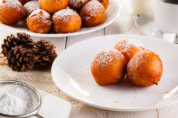 Sweet mini donuts - breakfast with coffee on white table