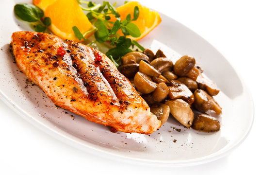 Grilled chicken fillet with mushrooms and oranges