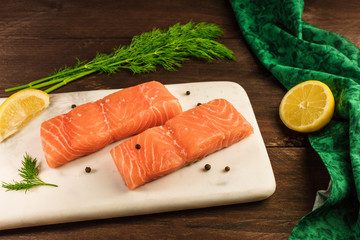 Two slices of salmon on dark background with copyspace