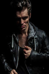 Fototapeta na wymiar serious portrait of a young man in leather jacket