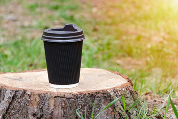coffee Cup stands on stump. Concept bright start of day