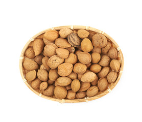 Wicker basket of almond nuts isolated