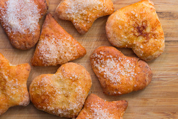 Cookies of different shapes with sugar for a Golden crust.