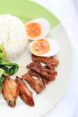 stir fried vegetables, Hard-boiled egg, Fried pork and Fried chicken wings with thai jasmine rice on dish. Thai food.