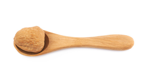 Walnut in a wooden spoon isolated