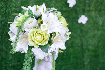 White and green artificial rose bouquet for wedding party decoration.