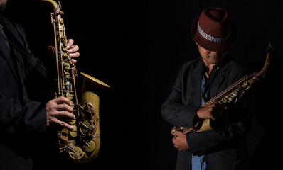 Fototapeta na wymiar A saxophone player in a dark background