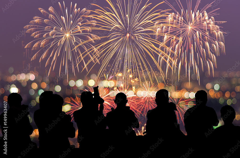 Wall mural The silhouette of reporter photograph the Fantastic festive new years colorful fireworks on cityscape blurred photo bokeh,project success, holiday concept