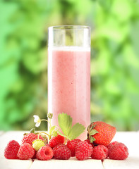 glass of smoothie on a wooden table in the garden