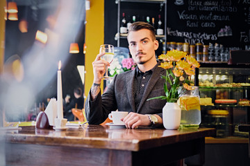 A man drinks wine.