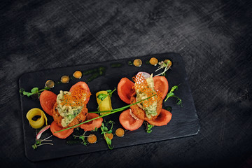 Seafood snacks with tomatoes.