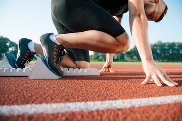 Runners preparing for race at starting blocks