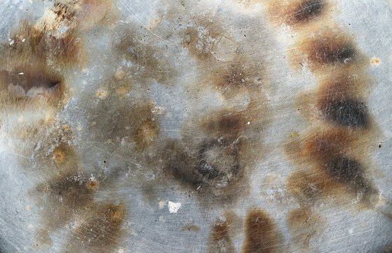 Brown stains on the silver surface that has white scratch on  the area,,Burn marks and Scratch effect,Gray abstract grunge background and  texture of old metal for add text or graphic design