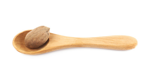Wooden spoon and pecan nut composition