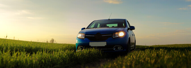 GOMEL, BELARUS - 6 May 2017: Beautiful blue car in the evening field sometimes.