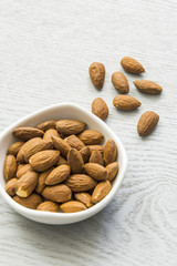 Almonds. Almonds on wooden table. Almonds background. Group of almonds. Peeled almonds. Pile of almonds. Almonds kernel. Almonds nuts.