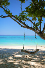 Wooden swing on the beach