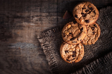 Obraz na płótnie Canvas Chocolate chip cookies, freshly baked on rustic wooden table. Selective Focus. Copy space.