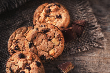 Chocolate chip cookies on dark old wooden table with place for text.,  freshly baked. Selective Focus with Copy space.