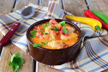 Traditional Hungarian dish witth paprika and chicken in a creamy sause In a ceramic pot. Healthy eating concept