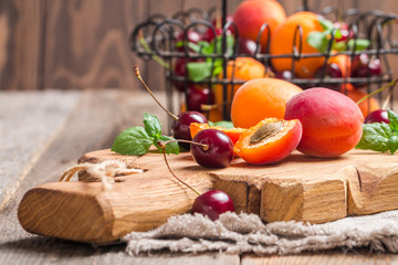  Apricots and cherries on rustic  background
