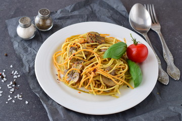 Pasta with mushrooms and pesto sauce in a white plate on abstract bckground. Italian lifestyle. Healthy eating concept
