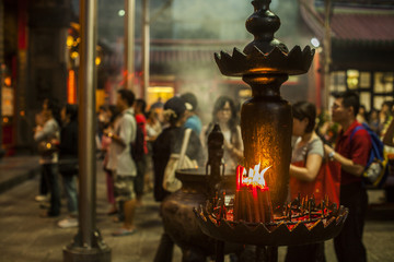 People praying and lighting incense at Longshan Temple in the center of the city