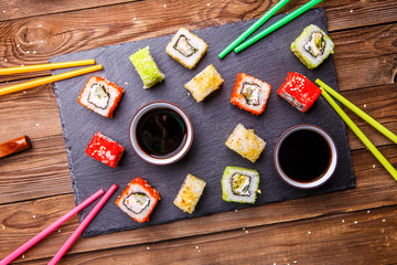 Obraz na płótnie Canvas Sushi Set rolls with soy sauce served on gray stone slate