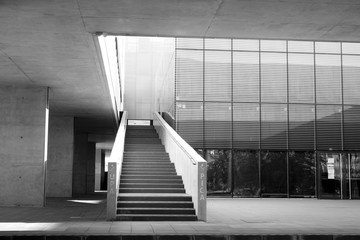 Cement concrete and metal structure in library building in black and white.