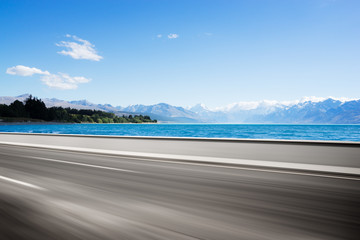 empty road with blue sea in blue sky