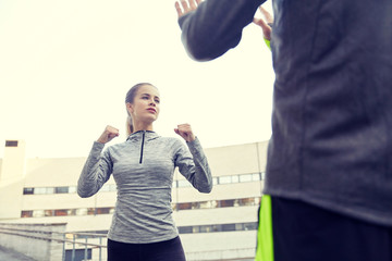 Naklejka premium woman with trainer working out self defense strike