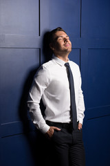 Youthful bristled businessman thinking and grinning