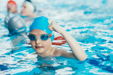 young and successful swimmers pose