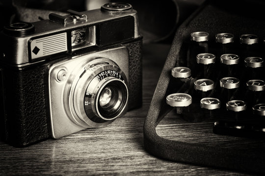 Old vintage retro camera with old-fashioned typewriter