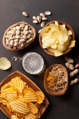 Lager beer and snacks on stone table