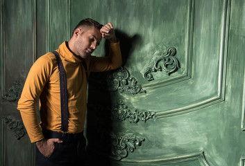 Thoughtful bristled man standing alone