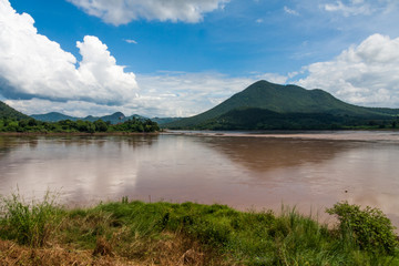 Naklejka na ściany i meble Looking across the Mekhong river from Thailand with Laos on the other side