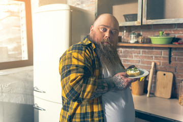 Man eating dessert in kitchen